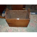 An oak handled wooden box with side studs, 15" tall x 18" long x 11 1/2" wide.