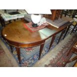 An elegant circa 1900 Mahogany 'D' end Dining Table standing on tapering square legs terminating