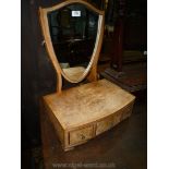 A light Walnut Swing Mirror having a bow-fronted three-drawer base and shield-shaped mirror.