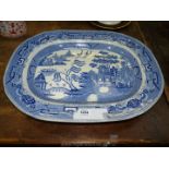 A large blue and white Willow pattern meat plate.