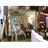 A large carved gilt-wood and gesso Over-mantel Mirror, the frame with leaf scrolls,