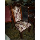 An elegant Walnut framed Side or Hall Chair of ecclesiastic flavour with intricately moulded front