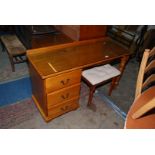 A contemporary lightwood finished Dressing Table having a flight of three short drawers to the left