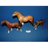 A Beswick horse and a Beswick foal plus another china horse.