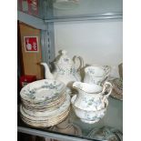 A Paragon part Teaset in 'Forget Me Not' design : four cups, six saucers and tea plates, cake plate,