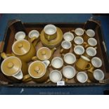 A Denby part coffee and part Teaset in a grainy mustard colour to include eleven coffee cups,