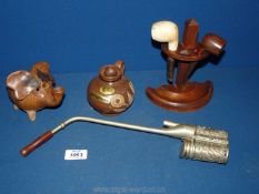 A wooden pipe stand with a pottery elephant piggy bank and pottery jug plus a metal opium pipe.