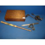 A vintage ground thermometer, wrought iron tower drill and set square in wooden box.
