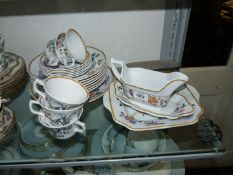 A part set of Wedgwood Devon Rose to include a large plate and sauce boat with square plate,