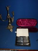 A set of silver handled knives, a case for a silver ladle and plated candelabrum.