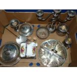 A box of silver plate including a three tier candelabra, two serviette rings,