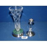 A silver based trumpet vase in cut glass and a silver topped and based candlestick with glass stem,