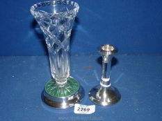 A silver based trumpet vase in cut glass and a silver topped and based candlestick with glass stem,