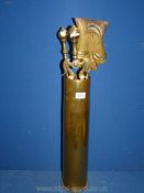 A brass companion set in a tall empty shell case dated 1918,
