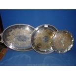 A white metal serving Tray, a silver plate Charger marked W.M.