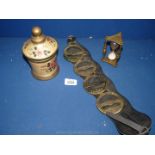 A quantity of brass including horse brasses, egg timer and brass pot with floral decoration.