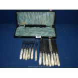 A quantity of mother of pearl handled dessert Knives and forks,