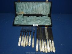 A quantity of mother of pearl handled dessert Knives and forks,