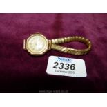 A Ladies 9ct gold Swiss made wristwatch with elasticated strap, London hallmarked.