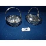 A pair of silver Bon Bon baskets with swing handles having saw pierced decoration,