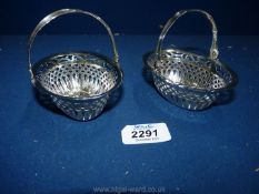A pair of silver Bon Bon baskets with swing handles having saw pierced decoration,