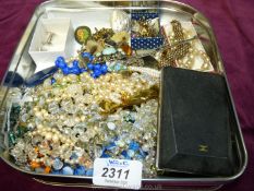 A box of mixed costume jewellery including brooches, clip-on earrings etc.
