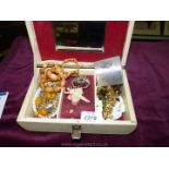 A small white jewellery box and contents including bead necklaces etc.