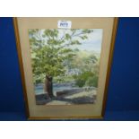A framed and mounted Watercolour depicting a country landscape with church and country lane,