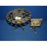 Two brass trivets both with spade legs, one with squirrel decoration the other with folding top.
