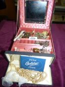 A box of costume jewellery in a brown fabric box.