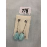 A pair of turquoise and silver drop earrings