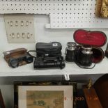 A pair of Hofleferant & Mahland binoculars and two others