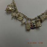 An early hm silver charm bracelet with 21 assorted very fine charms,