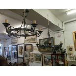 A pair of wrought iron chandeliers