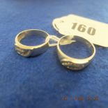 Two white metal and diamond rings set with 12 diamonds each,