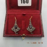 A pair of drop earrings set with sapphires and diamonds