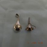 A miniature silver scent bottle and funnel