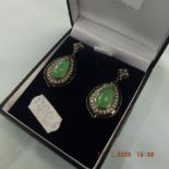 A pair of drop earrings set with Cabochon jade,