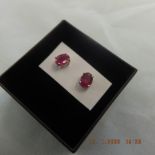 A pair of red gemstone and silver stud earrings