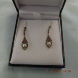 A pair of ruby pearl and diamond drop earrings