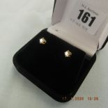 A pair of 18ct gold and diamond stud earrings approximately 0.