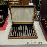 A silver plated set of fruit knives and forks in walnut canteen box