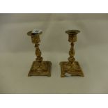 A pair of French ormolu rococo style candlesticks