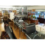 An extending glass top table and six Eames style elbow chairs