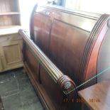 A mahogany sleigh bed