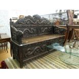 A fine quality Chinese 19th century oak box settle heavily carved dragons,