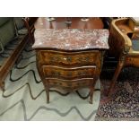 An inlaid marble topped serpentine fronted kingswood and rosewood marquetry inlaid chest of three