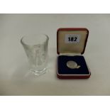 A shot glass from the wedding of Zara Phillips and a commemorative Diana & Charles coin