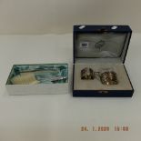 A boxed German 800 silver teacup holder with glass and matching silver napkin ring,