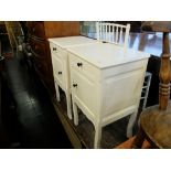 A pair of painted bedside cupboards and two bedroom chairs